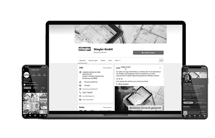 Ein Schwarzweißbild zeigt einen Laptop, auf dem das Social-Media-Profil eines Unternehmens mit Architekturdesign-Bildern angezeigt wird. Zwei Smartphones flankieren den Laptop und zeigen jeweils unterschiedliche Social-Media-Oberflächen an.